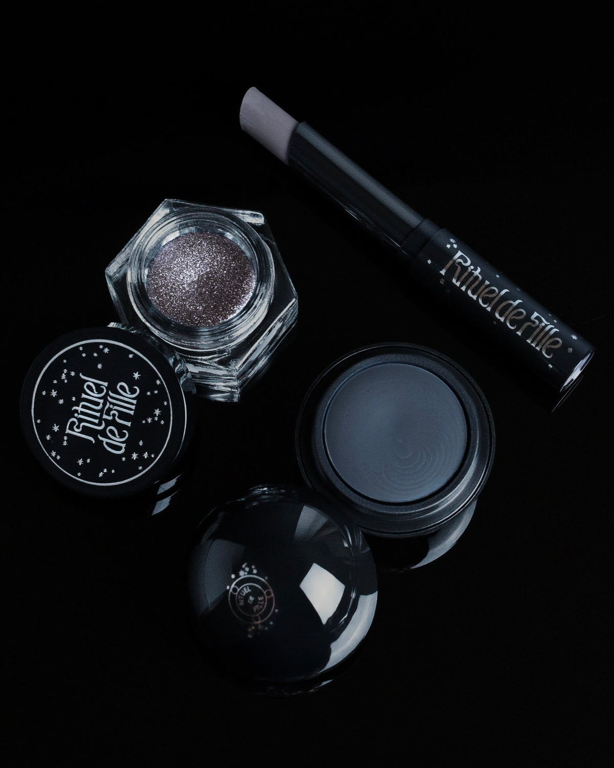 Three makeup items from Rituel de Fille arranged on a black background.