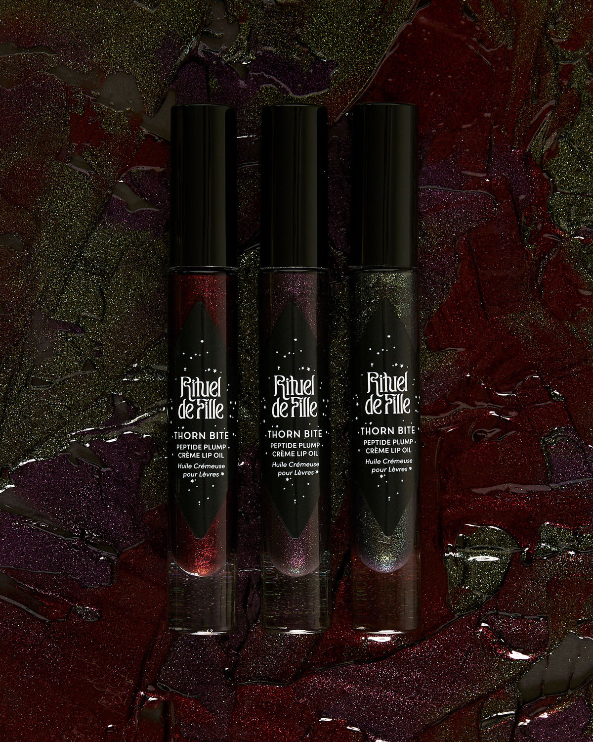 Group photo of multiple Thorn Bite lip oil shades