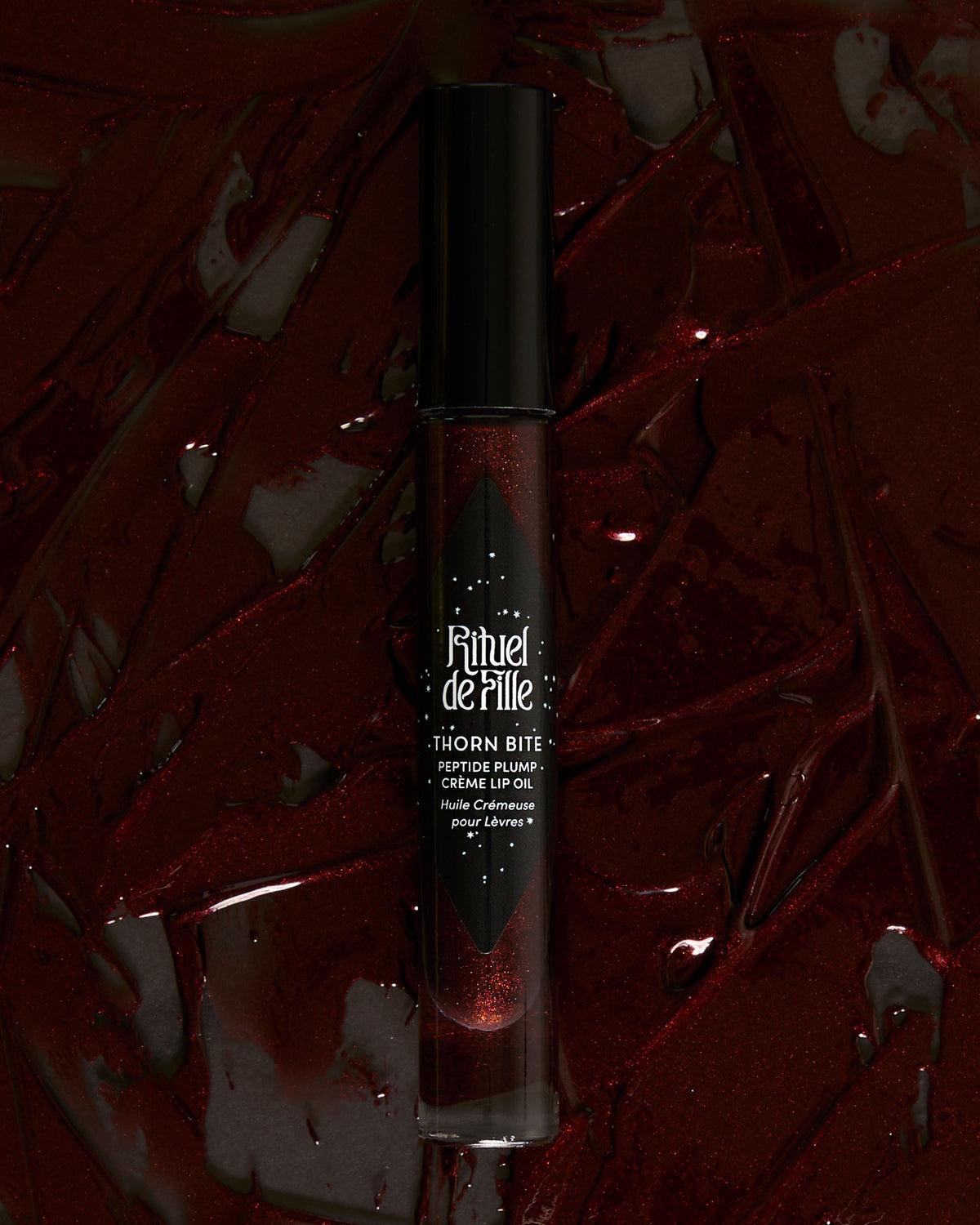Styled campaign photo of Night Flower lip oil in use