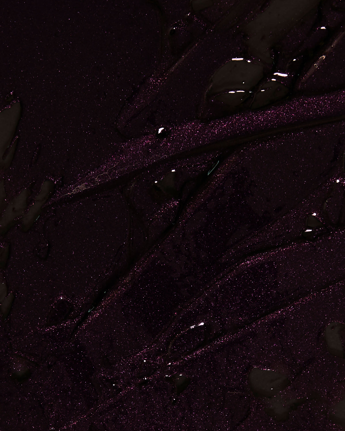 Close-up texture detail of Night Bloom Thorn Bite lip oil