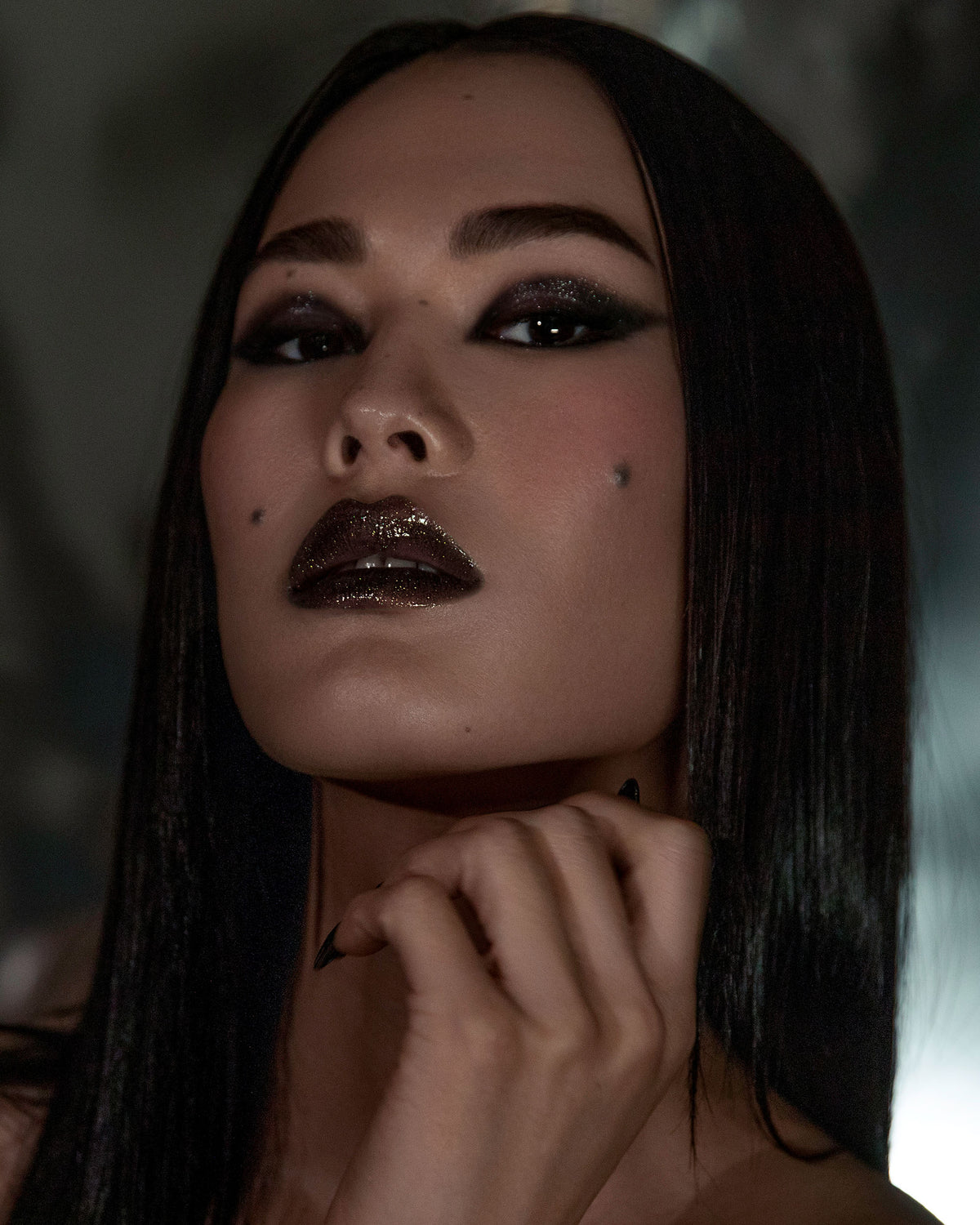 Model wearing Night Glow Thorn Bite lip oil shade