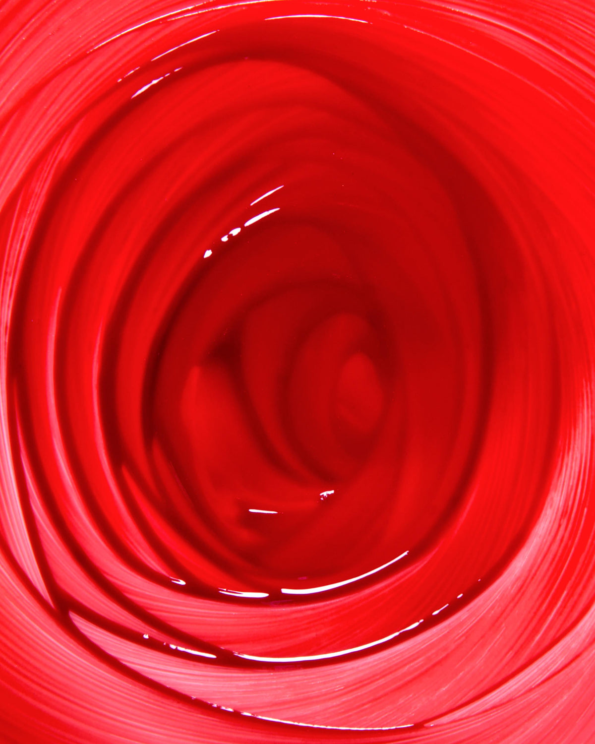 Close-up of cherry red makeup swirled in a circular pattern